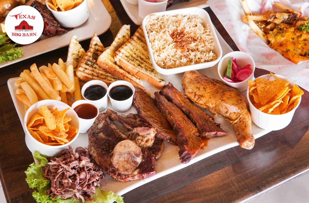 a plate of food with different types of BBQ meat and fries